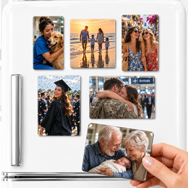 Glossy personalized 2x3 rectangular photo magnets displayed on a premium white refrigerator against a bright white background. Five custom photo magnets feature realistic lifestyle memories including a healthcare worker hugging her golden retriever, a family walking along the beach at sunset, two best friends laughing while exploring a colorful market wearing sunglasses, a graduate smiling with pride while walking across the graduation stage, and a military couple embracing during an emotional airport reuni